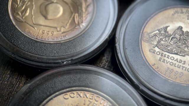 Macro Video of Reverse Side 1999 Washington Quarter State Coins in Capsules