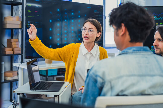 Professional Female Specialist Explaining Advanced AI Neural Network Data to Tech Team in Modern Office