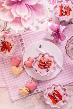 Strawberry curd cream with pink heart shaped macarons and sparkling wine for Mother's Day brunch