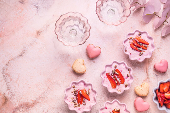 Strawberry curd cream with pink heart shaped macarons and sparkling wine for Mother's Day brunch