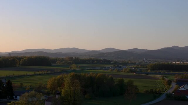 Evening panorama of Winzer Bavaria with rolling hills rural houses and golden sunset landscape view