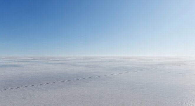 Vast, empty sky meeting a pale, hazy horizon over a minimalist landscape.