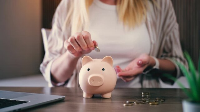 Careful woman putting coins into piggy bank, managing finances and building personal savings for future security, concepts of financial planning and investment