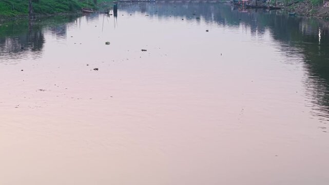 Environmental crisis establishing shot: Severe water pollution and habitat degradation at the Punpun and Ganges river confluence in India.