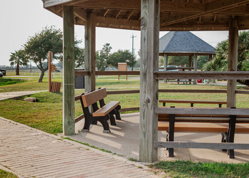 wooden gazebo with seating in the park
