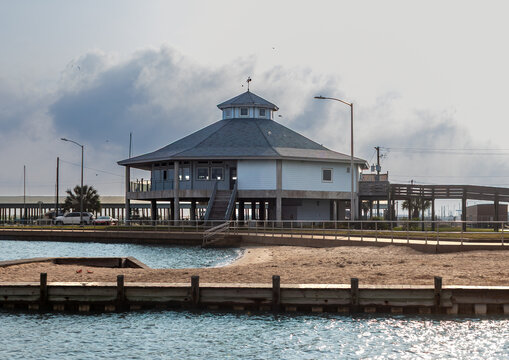 elevated building next to the ocean next to beach