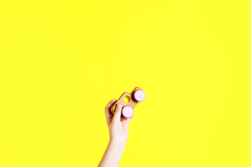 Fototapeta premium Child with toy car on yellow background, closeup. Space for text