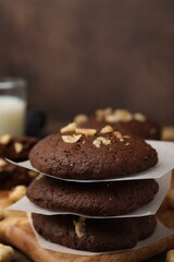 Fototapeta premium Tasty chocolate cookies with hazelnuts on table, closeup