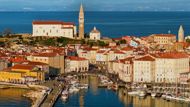 Piran Slovenia Golden Hour: Cinematic Port Side View with Medieval Towers and Adriatic Sea, Warm Sunset Light on Venetian Architecture, Mediterranean Aesthetics Lifestyle