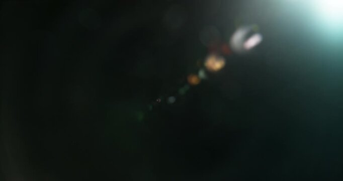 Slow motion cinematic lens flare and light leak effect isolated on black background. Perfect overlay for VFX, transitions, title reveals, film burn style and glow highlights.