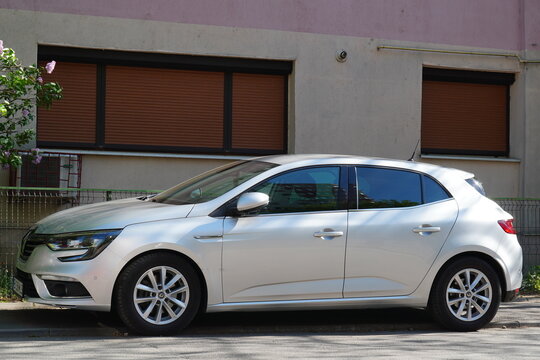 Bucharest, Romania &ndash; April 26, 2026: Closeup side view of Renault Megane Tce white car parked near apartment building