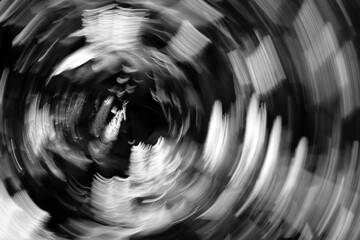 Abstract black and white swirling motion blur background symbolizing anxiety, stress and mental overload. Dynamic spiral composition expressing confusion, loss of control, dizziness  © Olga Lyubochkina