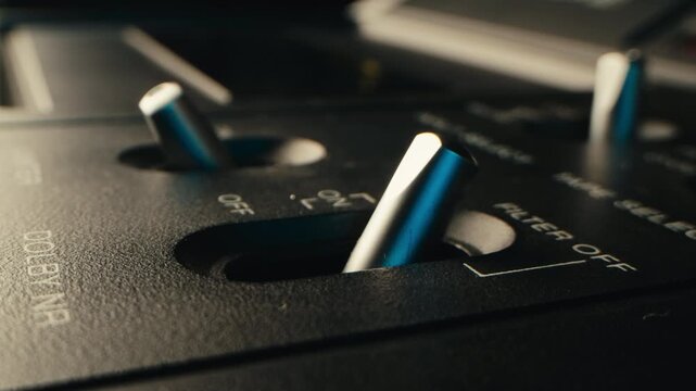 Retro radio tape recorder, audio cassette close-up. Listening to music, old radio boom box player, macro of vintage music listening. 