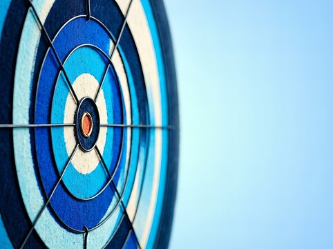 Close-up of a dartboard with blue concentric circles in sharp focus.