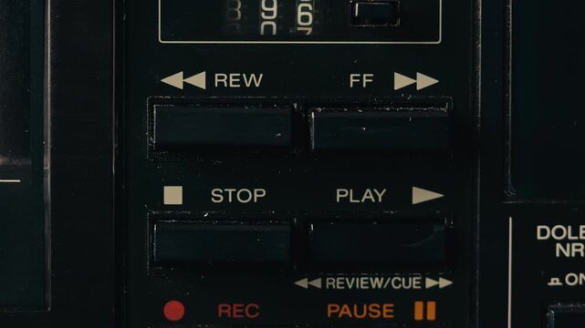 Retro radio tape recorder, audio cassette close-up. Listening to music, old radio boom box player, macro of vintage music listening. 