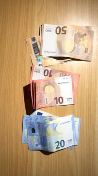 Hands counting euro banknotes