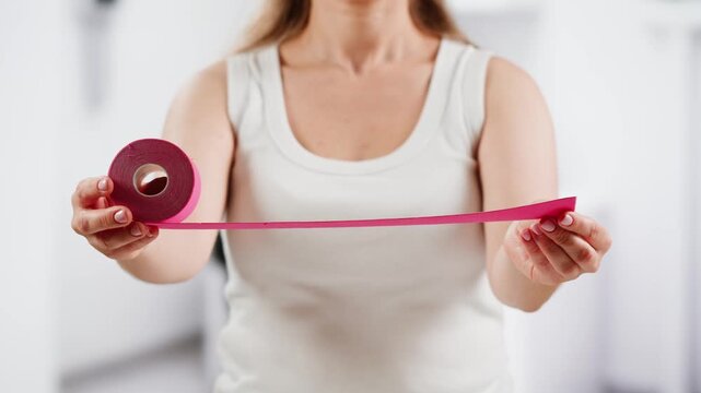 Kinesiology medical taping, doctor Physical therapist applying elastic surgical tape to patient body, treating injured knee young athlete.Post traumatic rehabilitation, sport physical therapy recovery