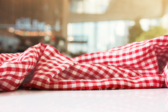 Checkered Picnic Fabric on White Table and Bokeh Green Restaurant Background 4k