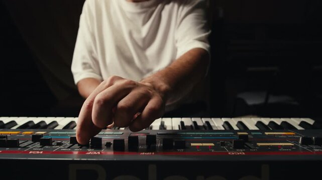 Playing piano vintage retro synthesizer. Close up of man hands playing jazz on the piano. Fingers on the piano, vintage colors. A very close look at a jazz pianist hands. Man playing the piano, close