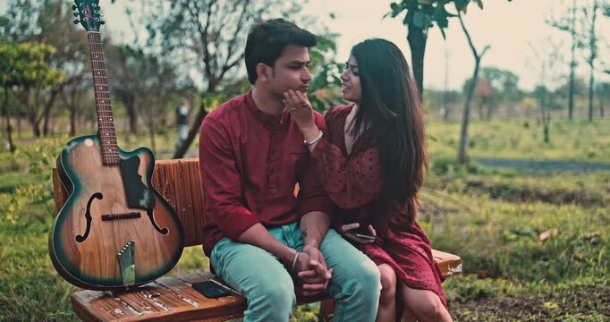 A couple reunion in a park, a girl apologizing for being late to her boyfriend, an emotional love story showing patience, forgiveness, and affection in nature