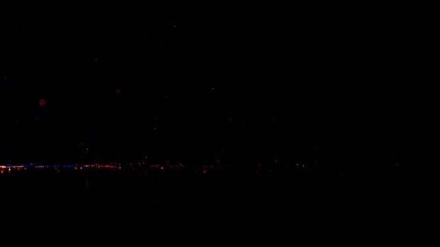3D animation. Abstract magical festive background. Blue, red, and gold sparks moving in a spiral trajectory, making loop in the air, sparkling glitter in the dark, whirling and fading