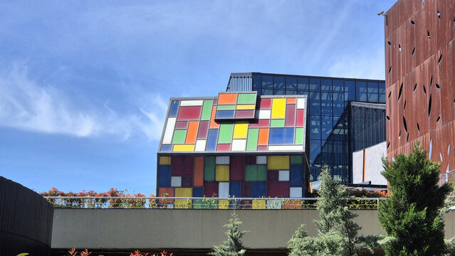 Colorful building with stained-glass panels reminiscent of Mondrian art, set against a modern glass and steel structure at Park Lake Shopping Mall, taken on April 27, 2026 in Bucharest, Romania.