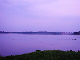 Fototapeta premium Tranquil Twilight Over Calm Water with Gentle Reflection and Fog