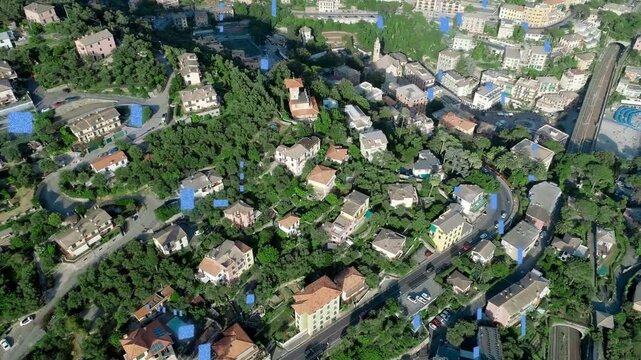 Camera panning right after takeoff, revealing hillside homes, promenade and drifting blue overlays