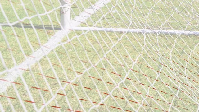 Camera starting lateral pan, goal net swaying and red markers appearing to showcase corner detail