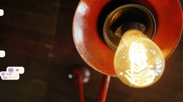 Camera moving closer, red filament bulb glowing, reaction icons rising from left showing engagement