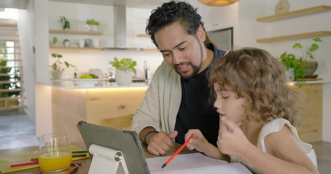Family dad guiding daughter reacting to tablet while doing homework at dining table with red pencil