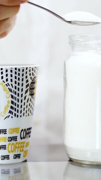 Add too much sugar in to coffee close-up slow motion