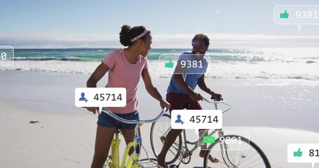 Naklejka premium Riding couple cycling along wet sand beach, wearing casual shirts, showing two bikes, social icons