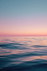 Fototapeta premium Calm, tranquil ocean sunset. Blurry water, soft pastel sky colors