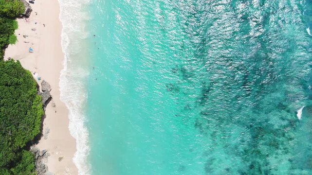 Tropical landscape with luxury beach with blue ocean and waves. Drone view, top down