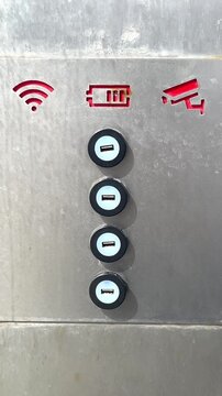 Charging station with USB ports and Wi-Fi indicator in a public area during the day