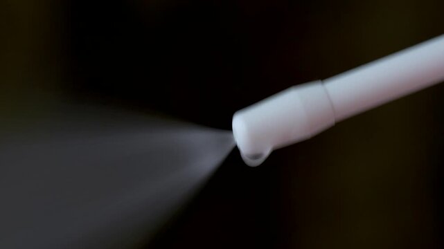 Macro Close-up of Spray Nozzle Dispersing Transparent Medicine Mist with Spraying Sound
