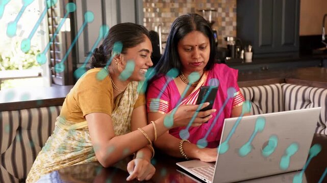 Daughter leaning in and showing phone, mother shifting from laptop, sharing funny tech moment