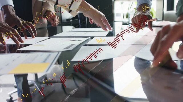 Vertical video: Business team tapping pad pointing docs on glass making motion charts linking data