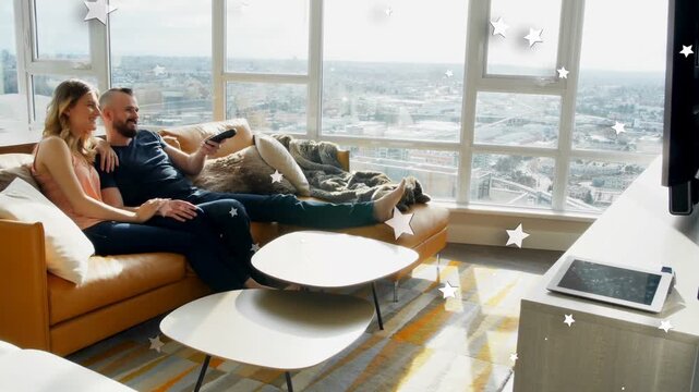 Man using remote changing show on sofa for TV, woman resting, stars shifting sparkling over couple