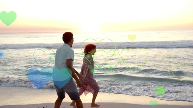 Pair sharing love on sunset shore woman running man reaching hearts floating over them for ads