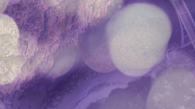 Soft overlay drift causing bokeh circles drifting right, revealing rough pale rock and rail