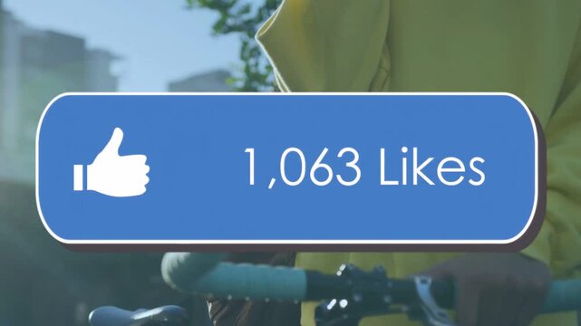 Male cyclist standing by bicycle, receiving likes and watching blue overlay updating for marketing