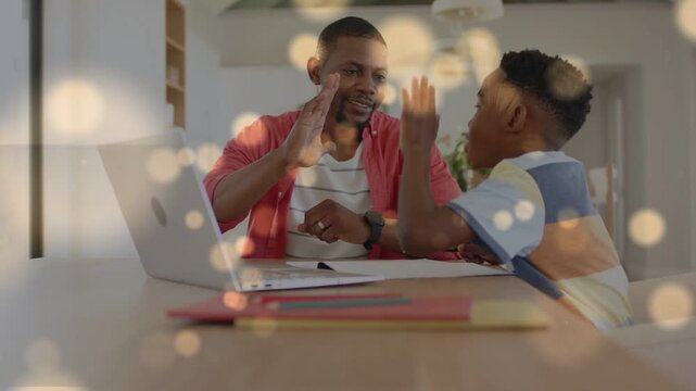 Dad raising hand inviting highfiving, son reaching, cheering study with laptop notes, bokeh overlay