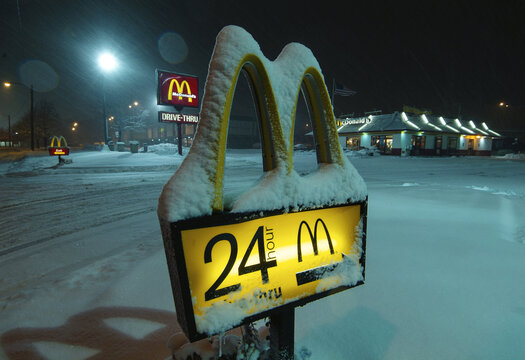 McDonald's Sign Covered in Snow Shows 24-hour Service at Night During Winter Weather