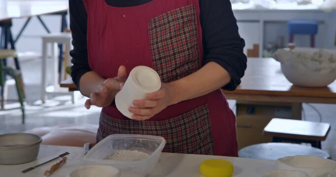 Crafting Clay: An artisan molds clay, bringing the form to life with care and detail, showcasing a passion for craft and a dedication to the creative process.
