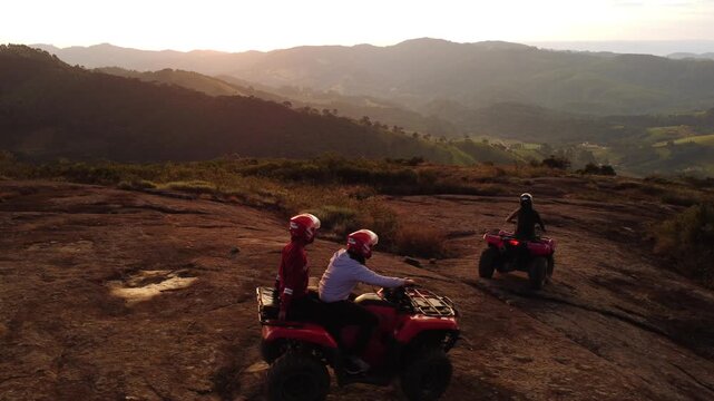 Aerial drone view of quad bike on mountain at sunset in Minas Gerais, adventure landscape