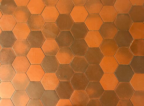 Urban surface and infrastructure texture. Orange hexagonal tile floor pattern.