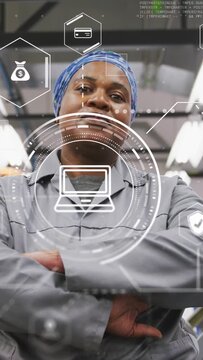 Vertical video: Factory tech swiping console, activating HUD showing laptop and finance icons