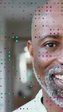 Vertical video: Mature man reacting to camera shift with dot overlay, smiling then laughing in ad